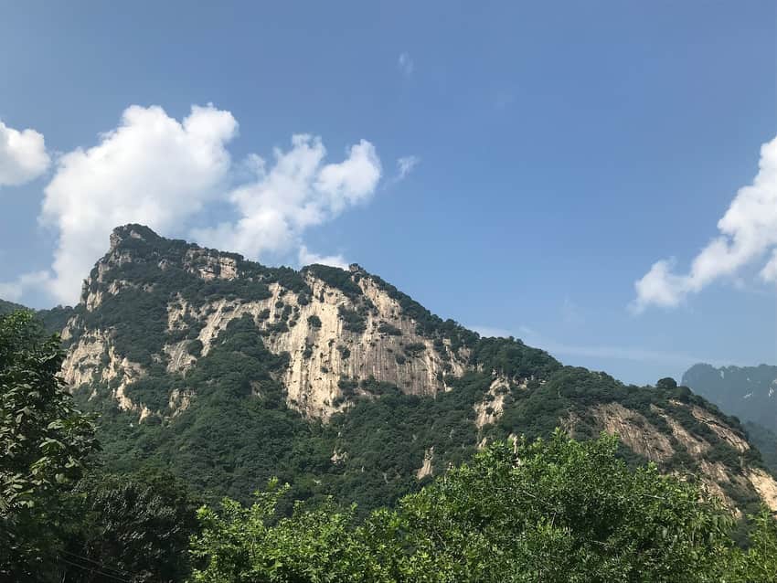 Pale rock face and forested slopes on Cuihua Mountain