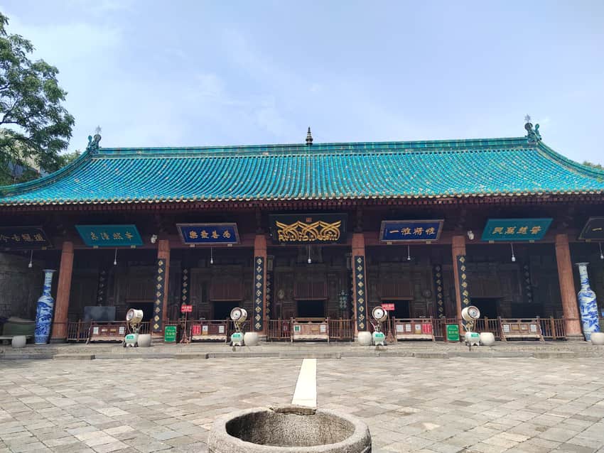Courtyard-facing hall with glazed roofs and calligraphic plaques at Xi'an Great Mosque