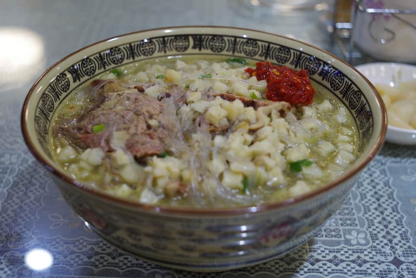 Yangrou paomo with torn bread, meat, glass noodles and chili condiment