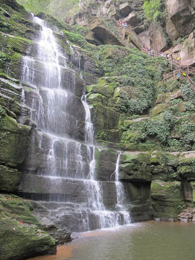 Layered waterfall and steep visitor stairs at Bifengxia