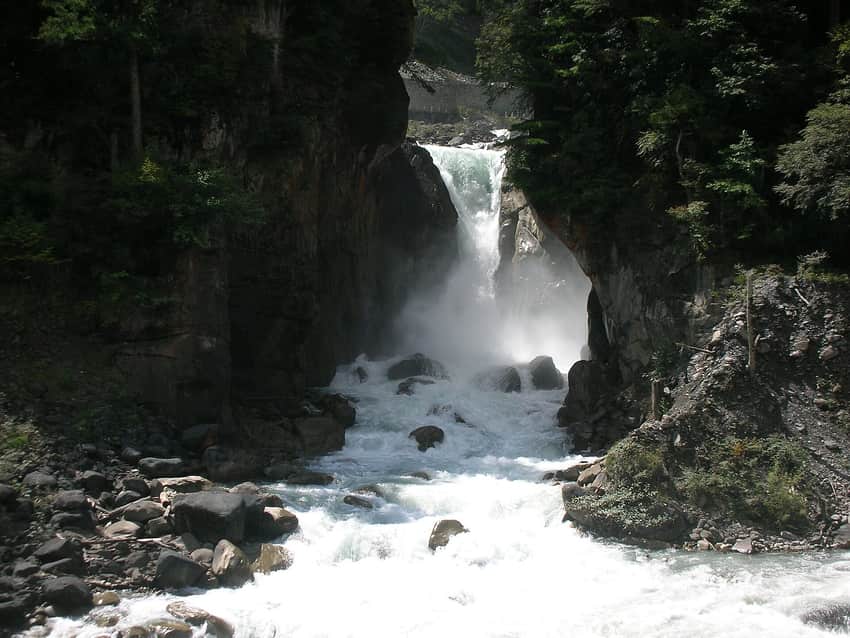 Tall Renzonghai waterfall descending through Shimian mountain terrain