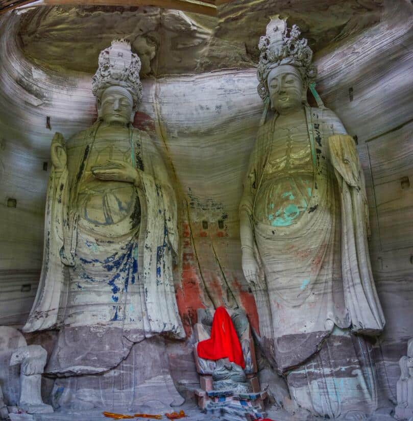 Two crowned standing figures in a shallow shelter at Mingshan Temple